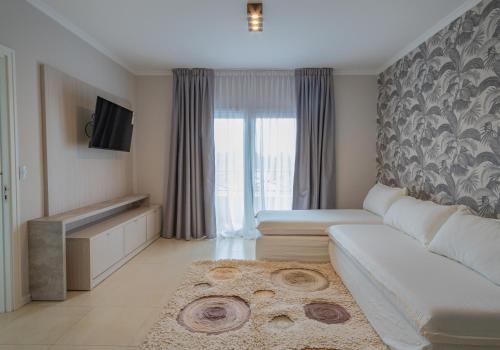 TV a/nebo společenská místnost v ubytování Garden Suites Pinamar