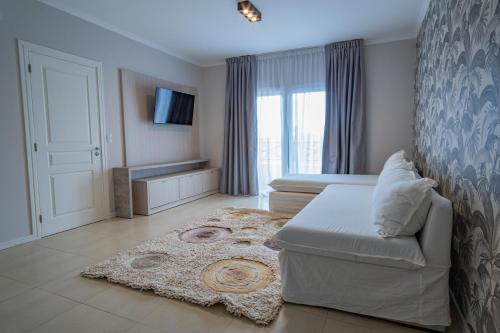 TV a/nebo společenská místnost v ubytování Garden Suites Pinamar