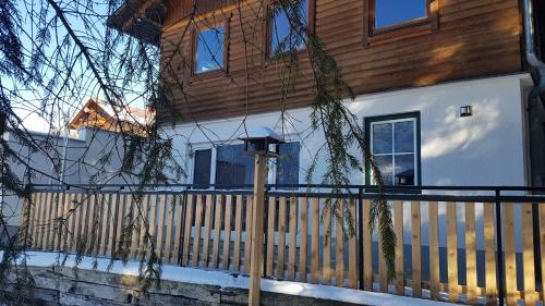 a house with a wooden fence in front of it at Apartment Katharina in Spital am Pyhrn