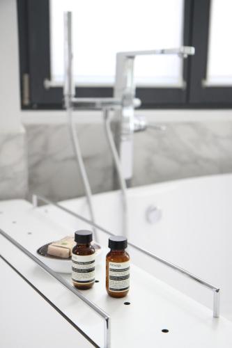 two bottles of honey sitting on a counter in a bathroom at Hôtel Quatorze in Colmar