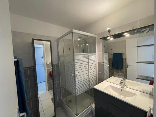 a bathroom with a glass shower and a sink at T2 à Saint-Clair - Vue exceptionnelle ! Classé 3 étoiles in Le Lavandou