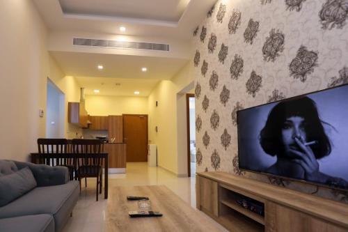 a living room with a large flat screen tv on a wall at The M Suite in Juffair