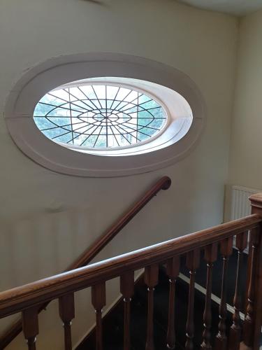 a round skylight in a stairway with a glass window at The Crown House Inn in Great Chesterford