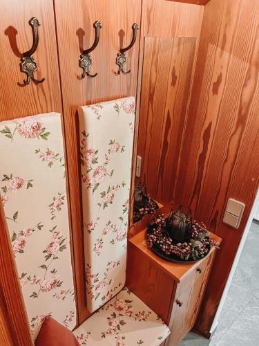 a refrigerator in a room with a table and a mirror at Hohlbichl Gut in Bischofshofen