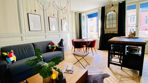 a living room with a couch and a table at Les Calins d'Honfleur in Honfleur