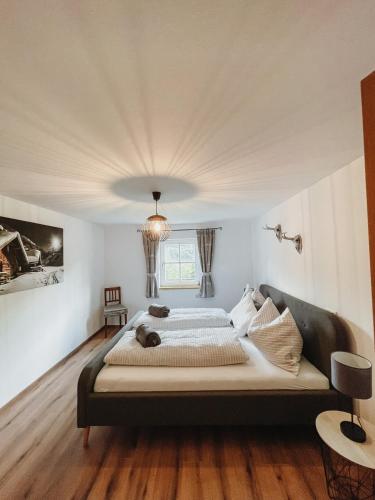 a bedroom with a large bed in a room at Hohlbichl Gut in Bischofshofen