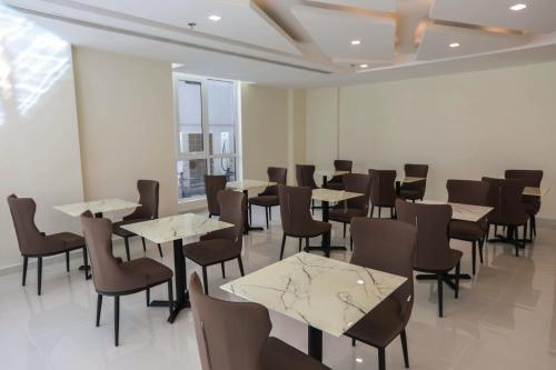 a dining room with tables and chairs in a building at The M Suite in Juffair