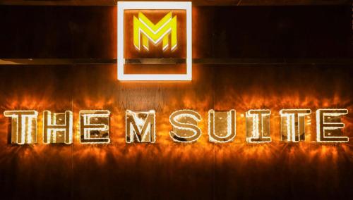 a neon sign that says the future in flames at The M Suite in Juffair