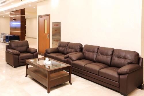 a living room with a couch and a coffee table at The M Suite in Juffair