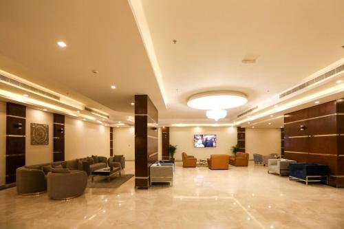 a lobby with couches and chairs in a building at The M Suite in Juffair