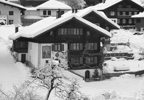 a house covered in snow with at Haus Mangard in Sankt Gallenkirch