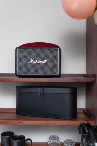 a black speaker sitting on a wooden shelf at The Dean Galway in Galway