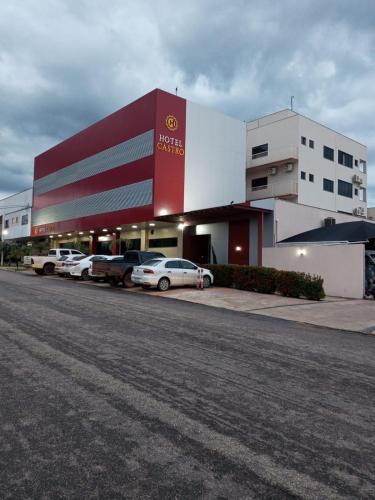 a car dealership with cars parked in front of it at Hotel Castro in Palmas