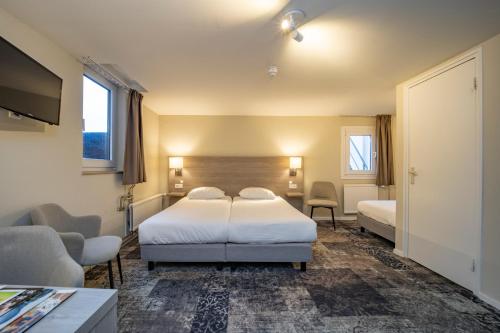 En eller flere senger på et rom på Fletcher Hotel Valkenburg