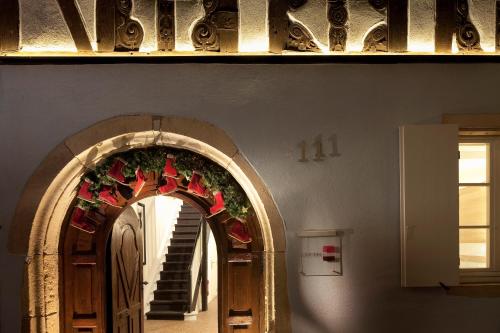 an archway with a christmas wreath on the wall at Hotel Le Colombier Suites in Colmar