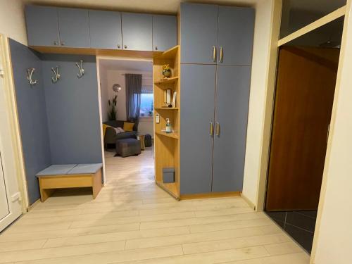 a room with a hallway with cabinets and a living room at DIS apartment Varaždin in Varaždin