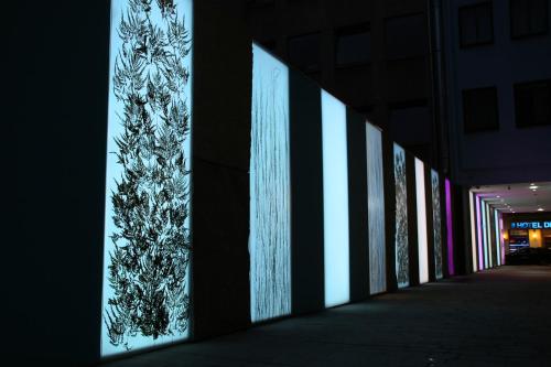 a row of lights on the side of a building at Schiller 5 Hotel in Munich