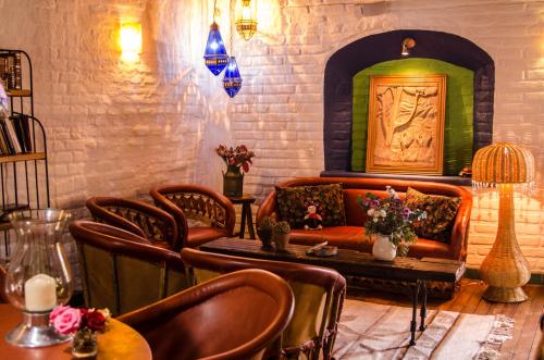 a living room with a couch and a table and chairs at Hotel La Casona in Tapalpa
