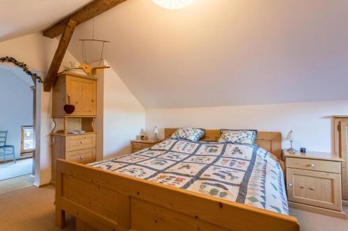 a bedroom with a bed with a wooden bed frame at Uriges Landhäuschen in Siegsdorf