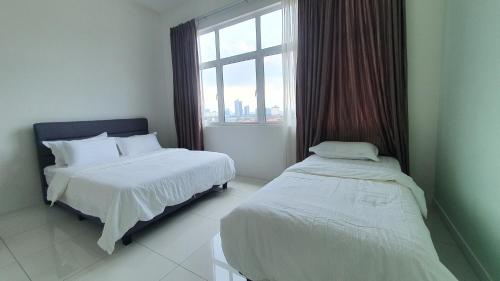 a hotel room with two beds and a window at No.13 The Bliss @ The Lovely Country Style House in Puchong