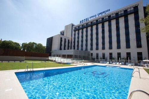 The swimming pool at or close to M.A. Hotel Sevilla Congresos