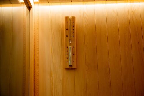 a light switch on a wooden wall at PIRANO Suite in Ceglie Messapica