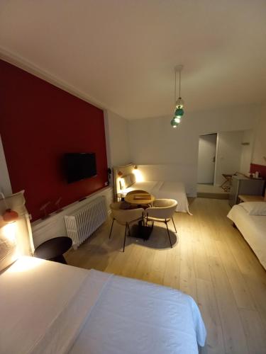 a hotel room with a bed and a table in a room at Hôtel La Caravelle in Ciboure