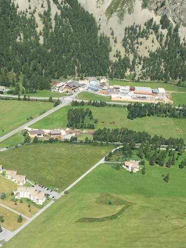 an aerial view of a park with houses and trees at Chesa Suot Ovas in Sils Maria