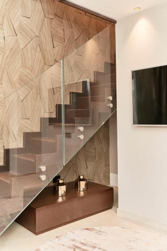 a staircase in a living room with a television at Palazzo Salomone in Siracusa