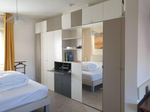 a bedroom with two beds and a glass partition at le Home Sweet Home d'Alice!!! à la Villa Alice Roger in Dunkerque