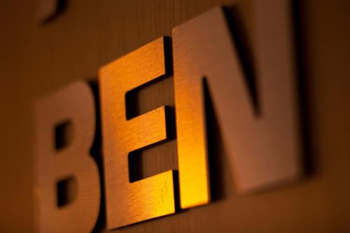 a close up of a wooden sign with the letter e at Hotel Le Pavillon 7 in Obernai