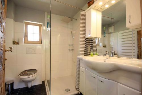 a bathroom with a sink and a shower and a toilet at Almliesl UTTE-629 in Uttendorf
