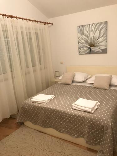 a bedroom with a bed with two towels on it at JELSA center-Sea view apartment near the beach - B2 in Jelsa