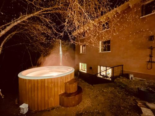 a bath tub in front of a building at night at CASA DEL AGUA - La Rioja in Santa Coloma