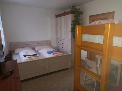 a bedroom with two bunk beds and a dresser at Penzion Domanín in Třeboň