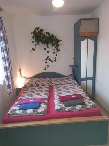 a bed with two pillows on it in a room at Penzion Domanín in Třeboň