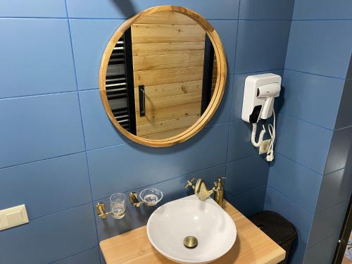 a bathroom with a sink and a mirror at BrickWood in Verkhniy Koropets