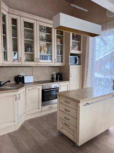 a kitchen with white cabinets and a counter top at Garmisch Lux Apartment mit Sauna in Garmisch-Partenkirchen