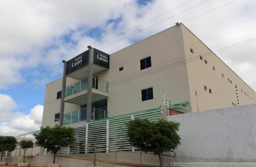 a building with a sign on the side of it at Hotel Leon in Barbalha