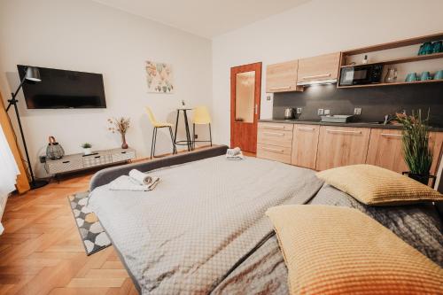 a kitchen with a large bed in a room at Elegant studio, 400m from the square in Plzeň