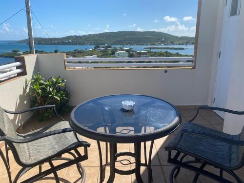 a dining room table with a balcony overlooking the ocean at Ulala Culebra in Culebra