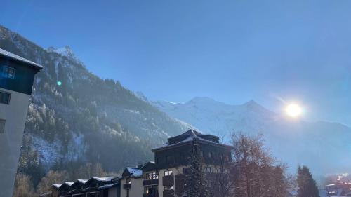 a view of a building with a mountain in the background at Chamois de Chamonix, Confortable 2 pièces, balcon, parking gratuit in Chamonix-Mont-Blanc