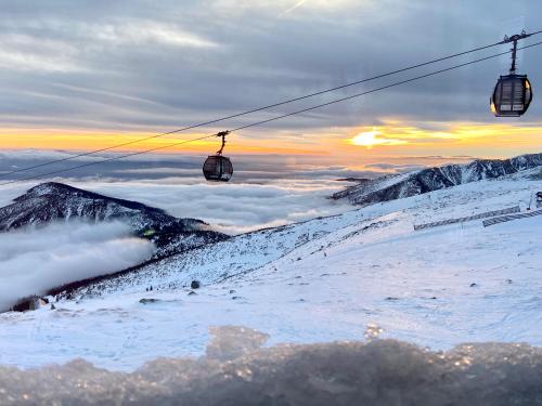 a ski lift on top of a snow covered mountain at KAPINA sk - Dom Jasna in Liptovský Mikuláš