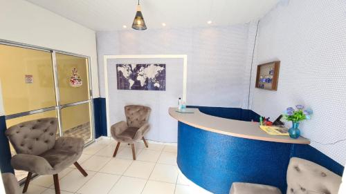 a room with a counter and two chairs in it at BeB Hotel in Macapá