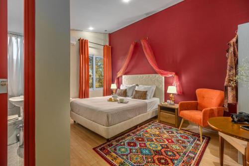 a bedroom with a bed and a red wall at Zen Hotel in Athens