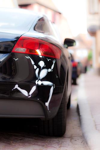 a back end of a car with a skeleton painted on it at Hotel Le Pavillon 7 in Obernai