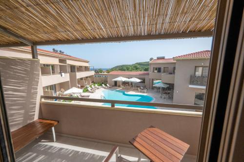 a view from the balcony of a hotel with a swimming pool at Scarabeo Suites & Villas Parga in Parga