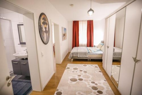 a small room with a sink and a bedroom at Turis Ferienwohnung 50-2 in Triberg