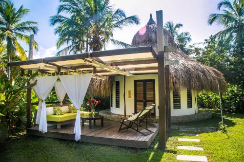 a white table topped with a white umbrella at Viajero Tayrona Hostel & Ecohabs in Buritaca
