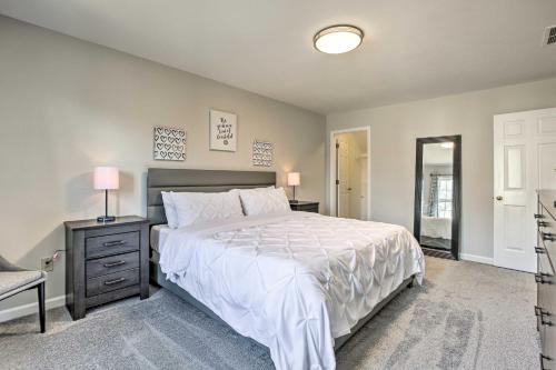 a bedroom with a bed and a dresser and a mirror at Deck and Yard Family-Friendly Lawrenceville Home! in Lawrenceville
